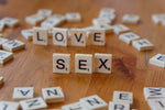 ξύλινα γράμματα scrabble που σχηματίζουν τις λέξεις love και sex, αισθησιακή διάθεση για το bodystocking First Lady μαύρο