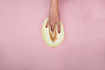 person holding sliced green fruit
