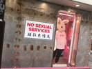 woman in pink dress standing beside glass window