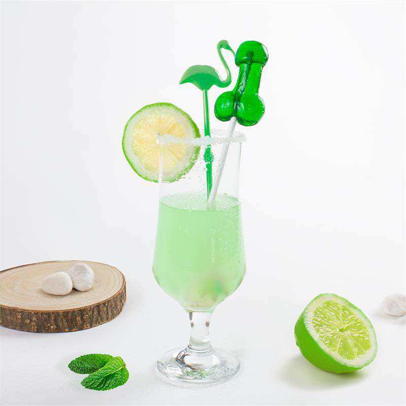 With Alcohol pale green cocktail in a clear stemmed glass, garnished with a lime slice, mint and green stirrers