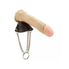 Ballstrecher shaped as a beige penis with a pink tip, black leather base, dangling metal chains and a ring