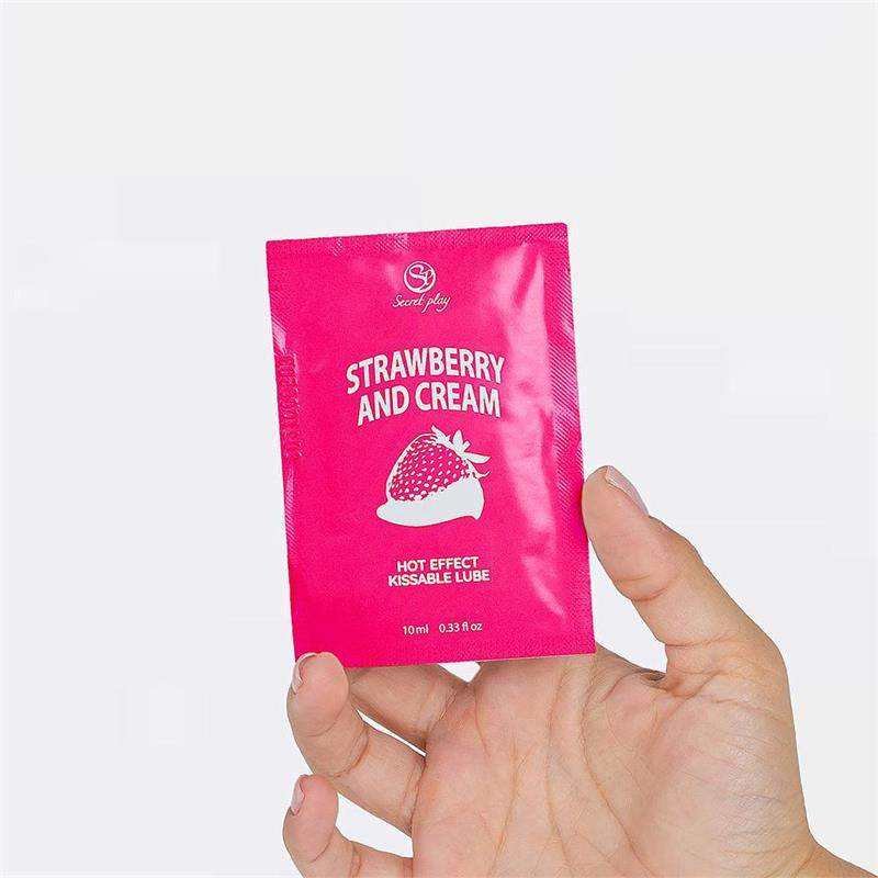 Single-Dose strawberry and cream lubricant sachet in bright pink packaging with strawberry graphics and hot effect label