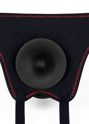 Adjustable Strapon with Dildo 7.5 featuring a black fabric harness with red stitching and a round central opening