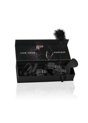 Beginners Bondage - Fantasy Kit in a black box with black leather restraints, a blindfold and feather tickler