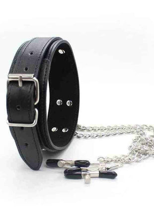 A black leather collar with a metal buckle, attached by silver chains to a pair of black-tipped nipple clamps.