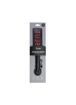 Black Leather Paddle - Slut in black leather, packaged with a red-lettered design and wrist loop handle.