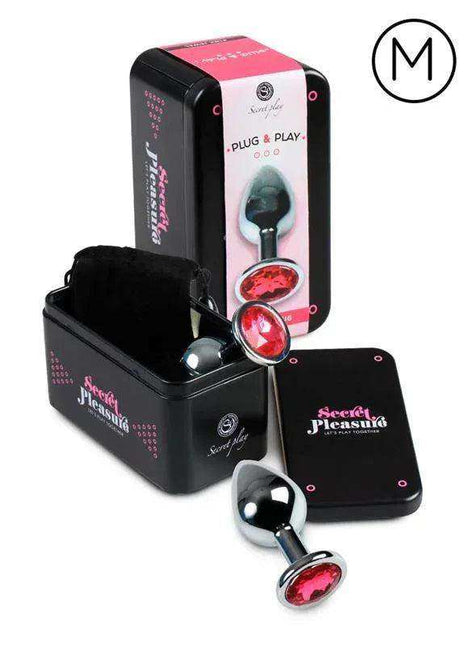 Butt Plug Size M with a polished silver-tone stem, faceted fuchsia jewel accents and a rounded end, shown with packaging