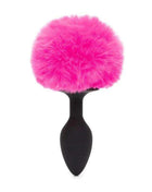Butt Plug with Pink Fur Tail featuring a smooth black tapered silicone plug and a large, fluffy hot pink tail