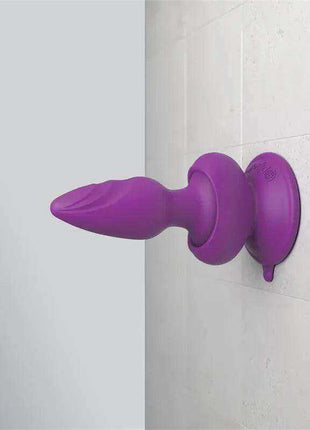 Butt Plug with Vibration in purple silicone, featuring a tapered curved plug and a broad circular suction-cup base