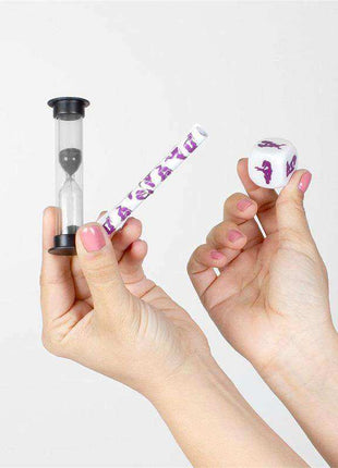 Chronomasutra Lesbian Couples Kit featuring a black-and-clear hourglass timer, purple-and-white patterned tube and matching cube held in hands