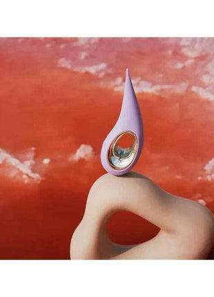 Clitoris Stimulator in lilac silicone with a pointed flexible tip and oval metallic detail, attached to a curved loop handle