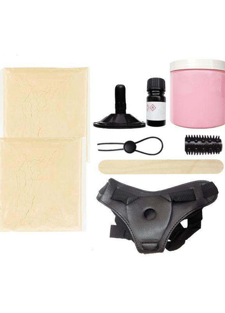 Cloneboy Dildo molding kit with beige modeling sheets, pink silicone, black harness, suction cup and small accessories
