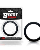 Cock Ring Solid Silicone in black, a thick circular silicone loop shown beside its retail packaging