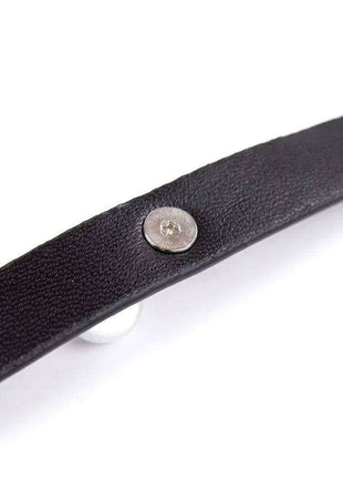 Collar with Bell in black textured material, featuring a silver metal snap fastener and a partially visible white bell