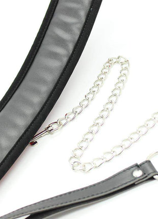 Collar with Metal Leash in black with a padded interior, stitched edges, metal buckle and silver chain leash