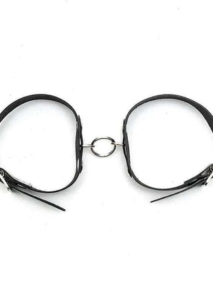 Cuffs Adjustable in black leather with slim straps, metal buckles and a central connecting ring