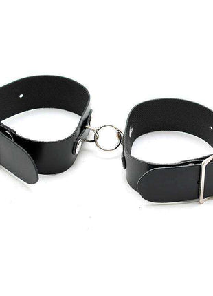 Cuffs Adjustable, a pair of black leather wrist cuffs with silver-tone buckles and a connecting metal ring