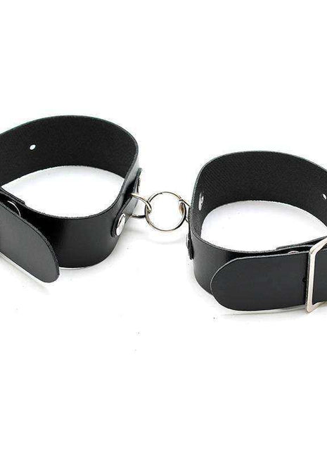 Cuffs Adjustable, a pair of black leather wrist cuffs with silver-tone buckles and a connecting metal ring