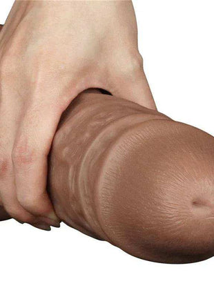 Dildo King 10.5 brown realistic dildo with textured veins and rounded tip, shown held in a hand