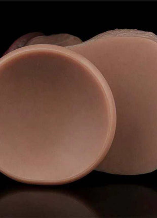 Dual Layered Dildo in muted brown silicone, shown with a broad rounded base and smooth, contoured shaft.
