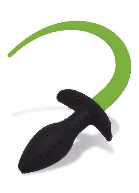 Butt plug with a black textured silicone base and long, curved green dog tail, described as Glow in the Dark
