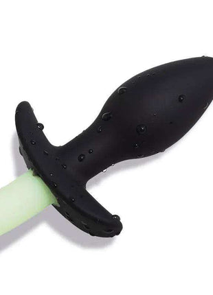Glow in the Dark dog tail butt plug with a pale green tail and black textured base with a flared stopper