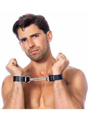 Hand and Feet Cuffs in black leather with silver buckles, connected by a short metal chain between the wrists