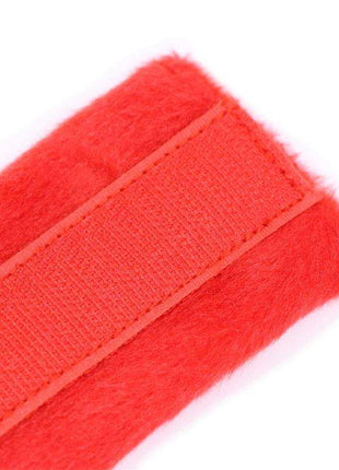 Red handcuffs with soft faux fur lining and secure Velcro closure for comfort and style