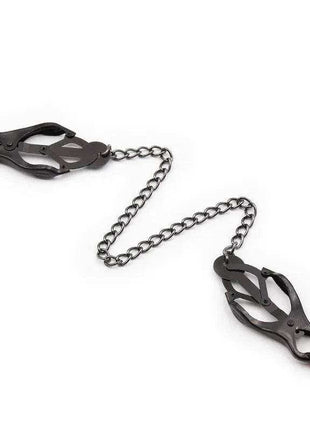 Japanese Nipple Clamps in black metal with adjustable gripping arms and a connecting chain between the two clamps