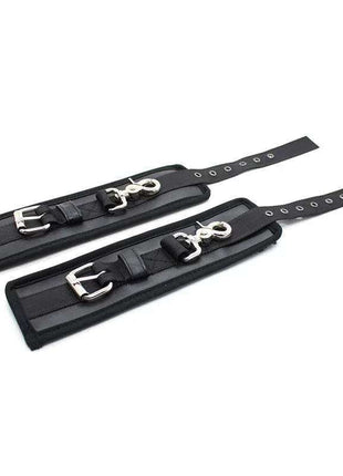Black leather handcuffs with large metal hoops for adjustable wrist restraint