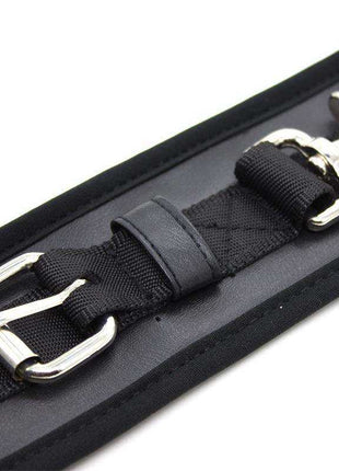 Leather Handcuffs with Big Hoops Black in black leather with adjustable woven straps, silver-tone buckle and metal rings