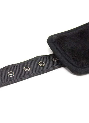 Leather Handcuffs with Big Hoops Black, showing a black textured adjustable strap with metal eyelets and a padded cuff