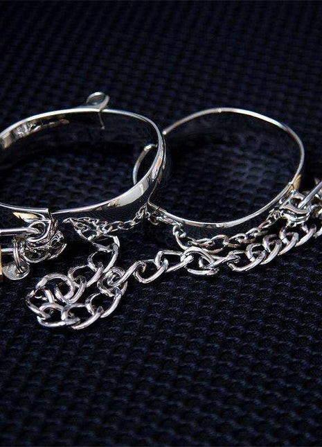 Metal Ankle Cuff for Women in shiny silver-tone metal with open oval bands, dangling chains and small gold-tone accents