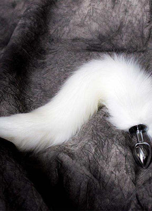 Metal Butt Plug with a polished silver finish and long, fluffy white fox tail attached at the base