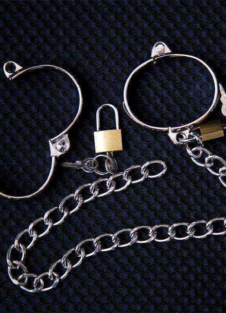 Metal Hand Cuff in shiny silver-tone metal with open circular bands, small gold-tone locks and a linked chain