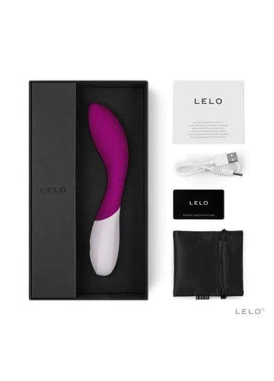Vibrating personal massager in magenta and white with a curved wave-shaped body, shown with charging cable and accessories; MONA WAVE Deep Rose