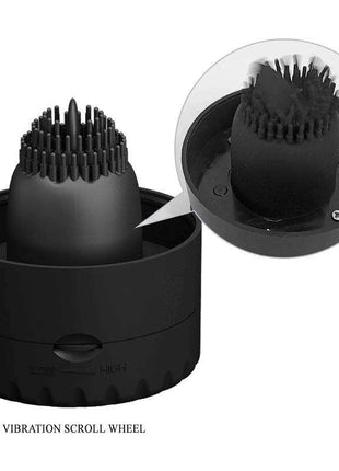 Naomi Masturbator With vibration is a black silicone male masturbator featuring a rounded sleeve with dense raised ridges and a vibration scroll wheel.