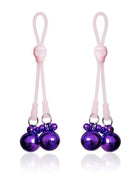 Pink purple nipple clamps with skulls and ring bells made of silicone and metal