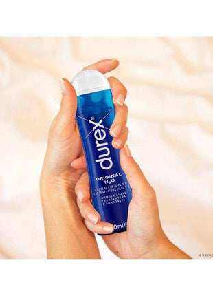 Original Lubricant Water-based bottle in a hand, with blue and white packaging and a white flip-top cap
