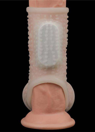 Penis and testicles sleeve in translucent pale pink TPE, with a ribbed shaft, raised bumps and a vibration panel.