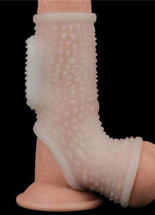 Penis and testicles sleeve in translucent pale pink TPE, with raised textured bumps and an open base