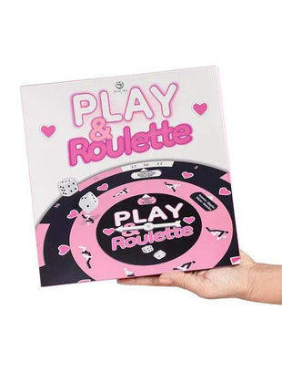 Play & Roulette board game with a pink, black and white roulette wheel design, heart graphics and dice on the box