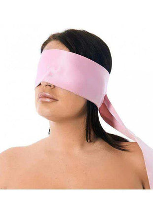 Premium Blindfold in smooth pink fabric, wide eye-covering band with long matching ties worn around the head