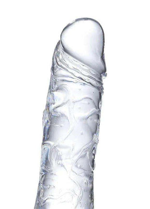 Realistic Dildo in clear crystal with a glossy surface, sculpted veins, and a gently curved shaft with rounded tip