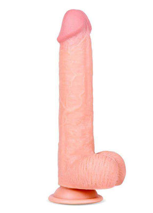 Realistic Dildo in pale pink textured material, with a darker pink rounded tip, sculpted testicles and suction cup base
