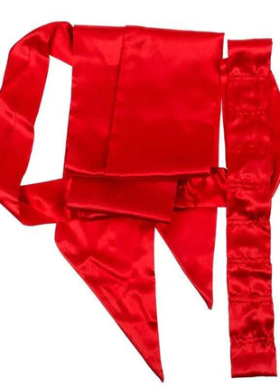 Red Sexy Costume Bow in glossy red satin fabric, shown as a wide bow with long pointed tails and attached straps.