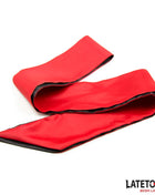 Satin Blindfold in bright red satin with black edging, shown as a long, wide fabric strip with folded sections.