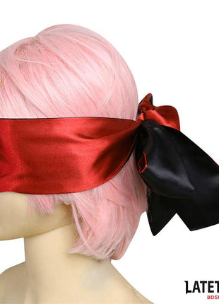Satin Blindfold in glossy red satin with a wide black ribbon tie, wrapped across the eyes on a mannequin
