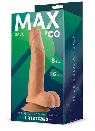 Saul Realistic Dildo with testicles in realistic peach-toned silicone, displayed beside green and navy retail packaging