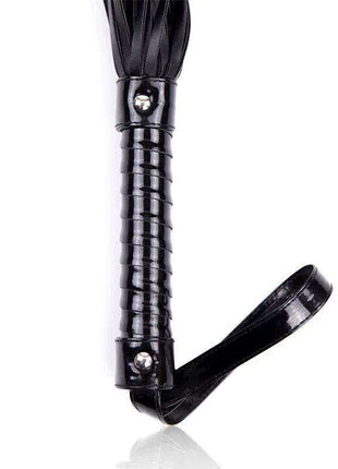 Shinny Handle Flogger with a glossy black ribbed handle, silver fasteners and bundled black tails